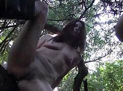 Lesbian lovers passionately lick in the woods.