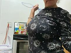 Anna Maria, that mature black Latina, teases with her big tits and ass in workout apparel.