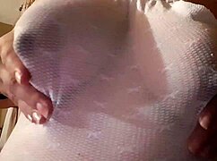 Sexy Latina shows off her big lactating nipples.