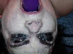 Ms. TL demonstrates throat techniques with toys and dildos in a messy setup