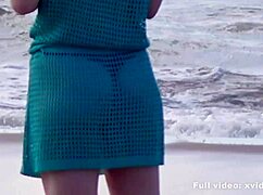 a boy reads relaxed but she does this to him on the beach