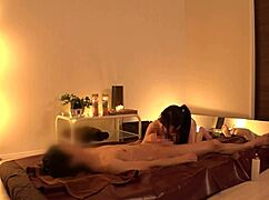 This cute Japanese babe's tiny skirt flips up, showing panties at the massage parlor.