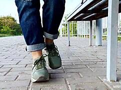 feet goddess teases with tan nylon soles and blue jeans on the bench