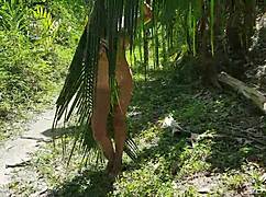 A naked tall girl is photographed in the wild amazon jungle.