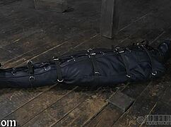 The restrained girl gets punished in the garage.