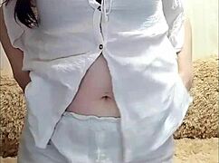 Horny brunette stripteases