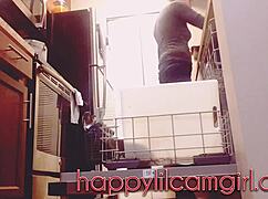 tall girl dominates kitchen cleaning while recording voyeur webcam.