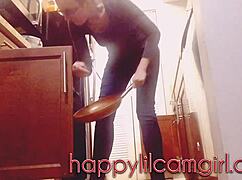 tall girl dominates kitchen cleaning while recording voyeur webcam.