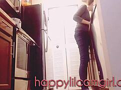 tall girl dominates kitchen cleaning while recording voyeur webcam.