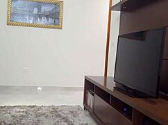 Curvy tanned housewife with tattoos teases the TV technician in short shorts, showing her big ass.