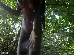 Naked Skinny Tribe Woman Crafts Bow for Hunting