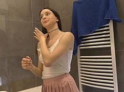 Braless hot brunette skinny and horny babe in a pink mini skirt to show her beautiful ass and legs in the bathroom