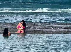 Two gorgeous girls enjoying the beach at enseada dos corais in cabo, pe, with kissing and outdoor fun.