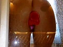Is this girl with an appetizing ass having fun in the shower with a pink dick?