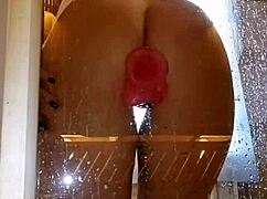 Is this girl with an appetizing ass having fun in the shower with a pink dick?