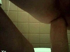 she's pleasuring herself with a huge dildo insertion at home.