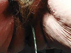 oma inserts cucumber into her hairy pussy for some fun