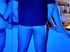 Wife eagerly sucks two cocks in neon light threesome scene 😏