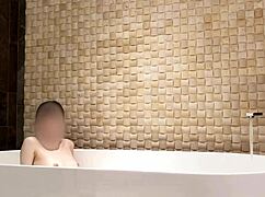 cute skinny japanese brunette bathes in luxury hotel shower